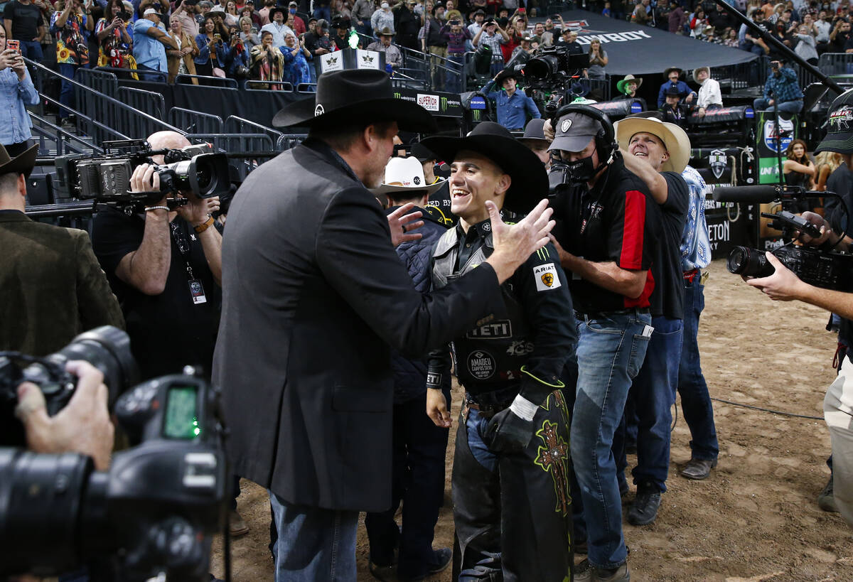 Jose Vitor Leme, right, celebrates after becoming the back-to-back PBR World Champion during th ...