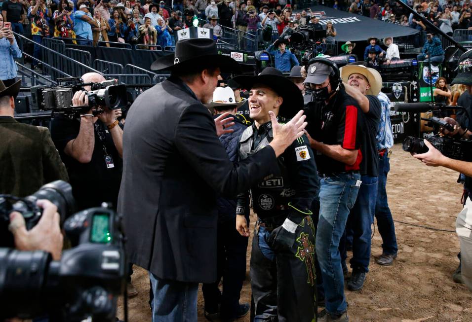 Jose Vitor Leme, right, celebrates after becoming the back-to-back PBR World Champion during th ...