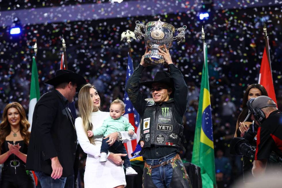 Jose Vitor Leme celebrates alongside his son, Theodoro, and wife, Amanda, after becoming the ba ...