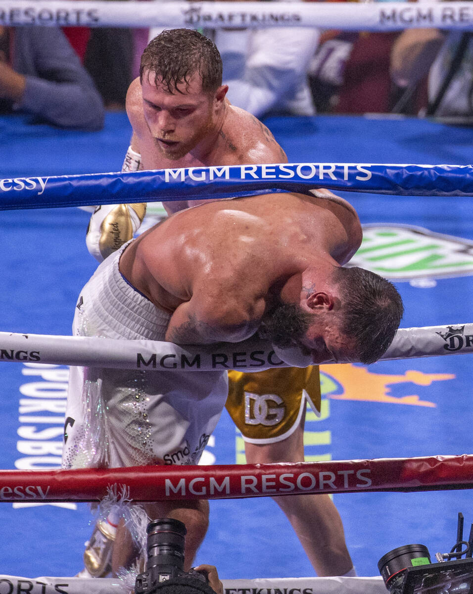 Saul "Canelo" Alvarez sends Caleb Plant through the ropes in the 10th round during th ...