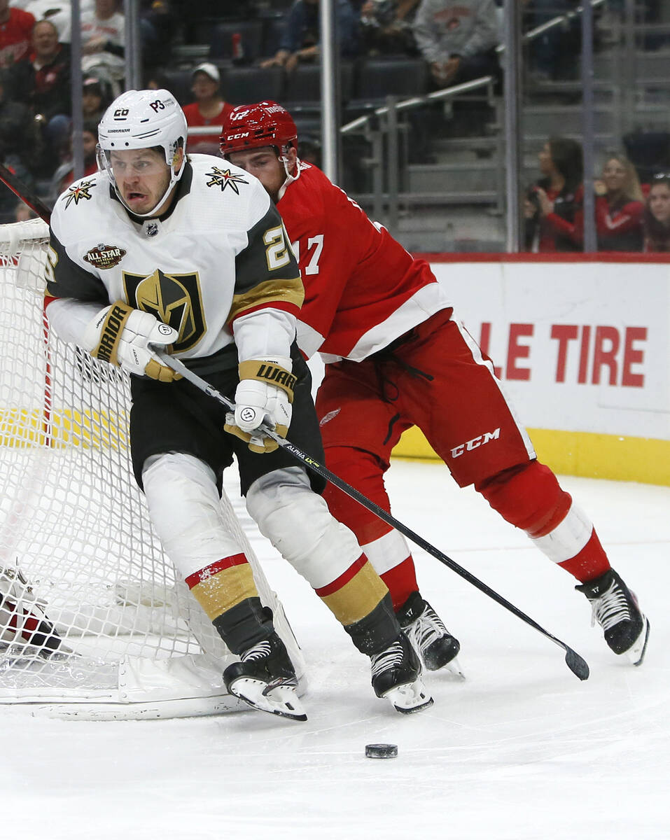 Vegas Golden Knights center Mattias Janmark (26) is pursued around the net by Detroit Red Wings ...