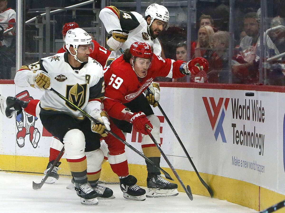 Vegas Golden Knights defensemen Alec Martinez (23) and Nicolas Hague (14) try to get Detroit Re ...