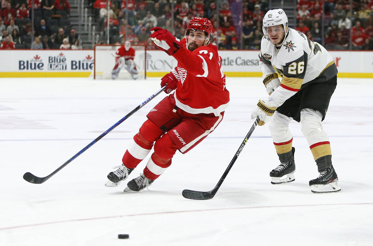 Detroit Red Wings center Dylan Larkin (71) skates past Vegas Golden Knights center Mattias Janm ...