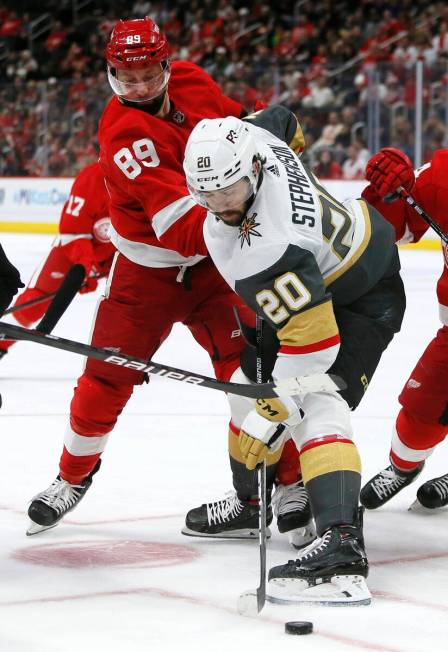 Vegas Golden Knights center Chandler Stephenson (20) battles Detroit Red Wings center Sam Gagne ...