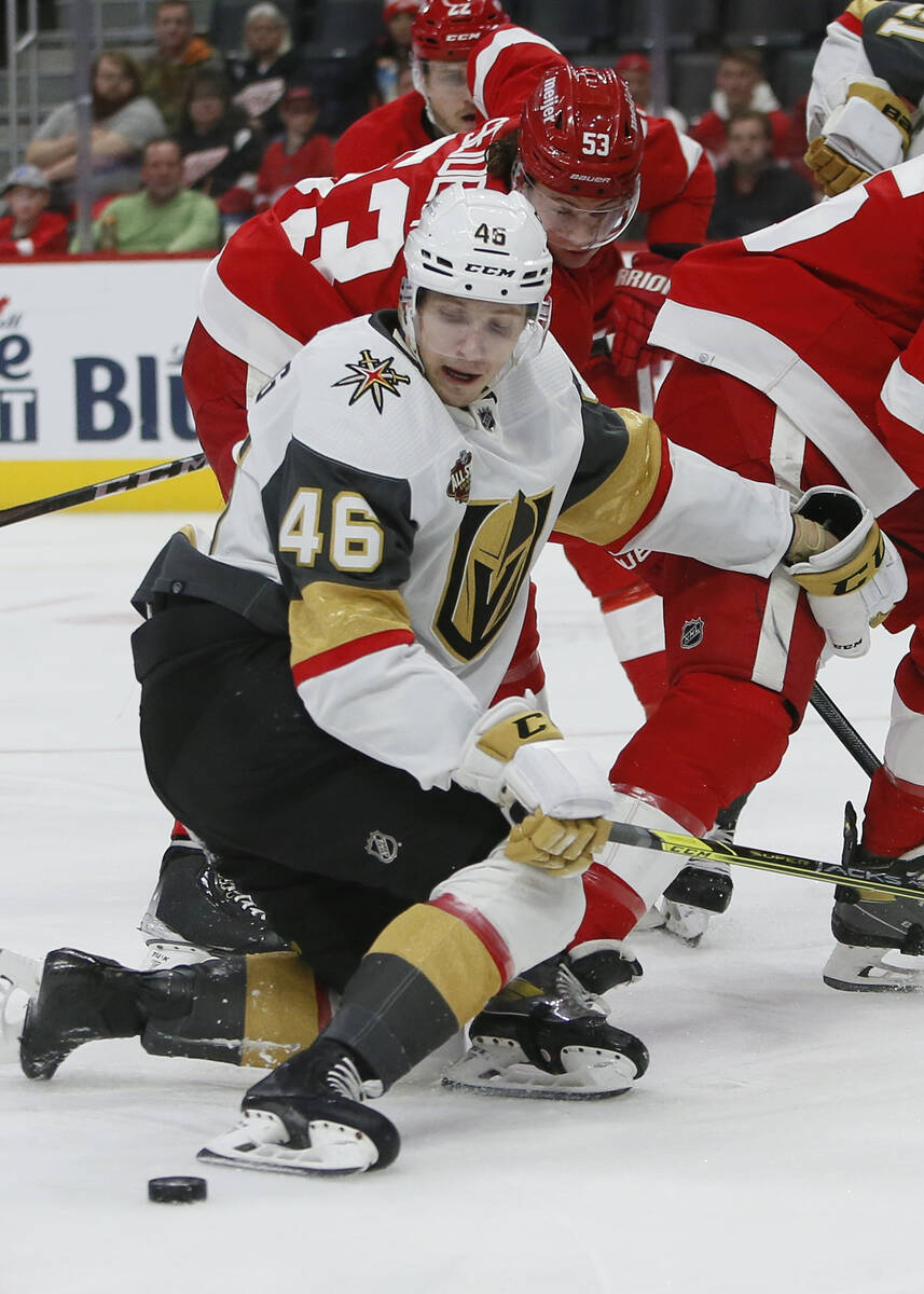 Vegas Golden Knights' JonasRondbjerg (46) can't control the puck against Detroit Red Wings defe ...
