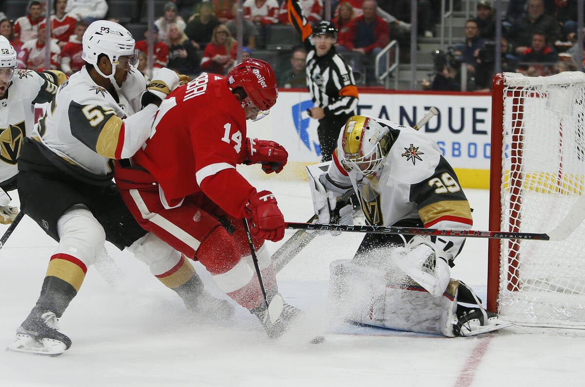 Detroit Red Wings center Robby Fabbri (14) is tied up by Vegas Golden Knights right wing Keegan ...