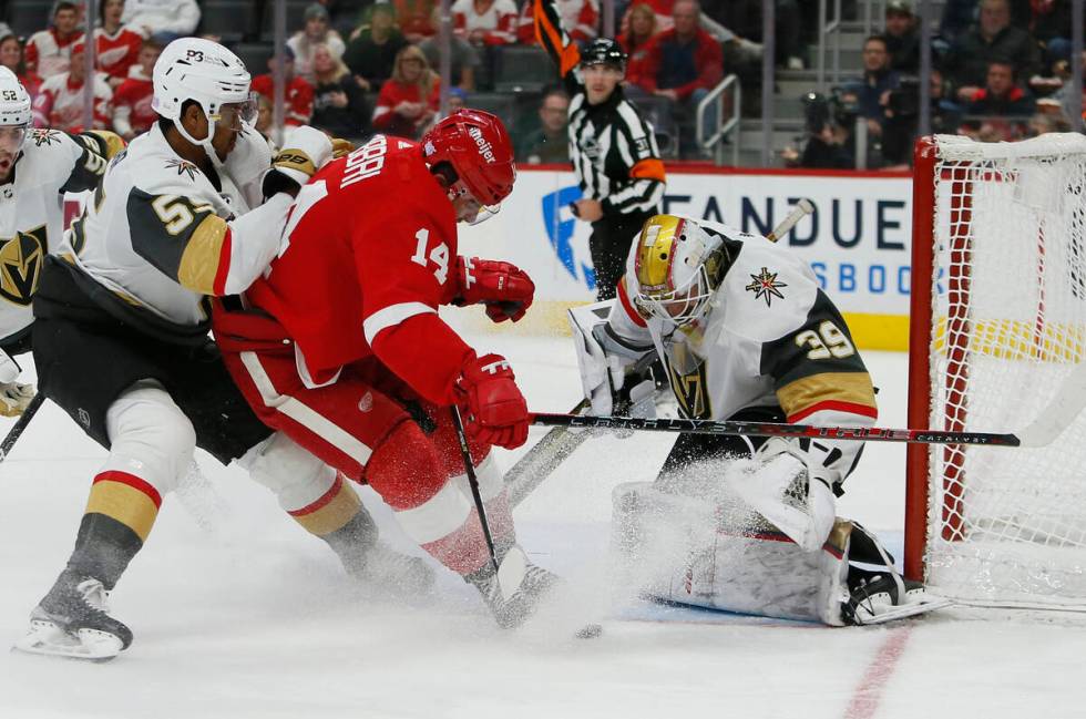Detroit Red Wings center Robby Fabbri (14) is tied up by Vegas Golden Knights right wing Keegan ...