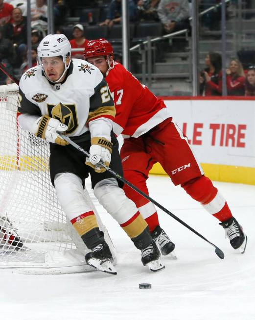 Vegas Golden Knights center Mattias Janmark (26) is pursued around the net by Detroit Red Wings ...