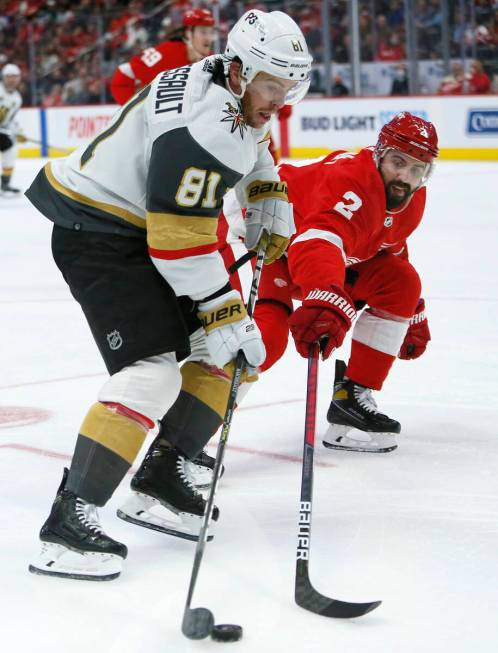 Detroit Red Wings defenseman Nick Leddy (2) tries to steal the puck from Vegas Golden Knights c ...