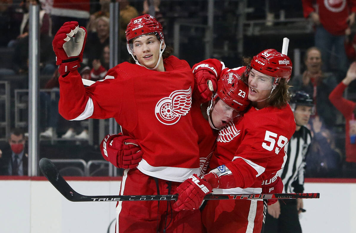 Detroit Red Wings left wing Lucas Raymond (23) celebrates with defenseman Moritz Seider (53) an ...