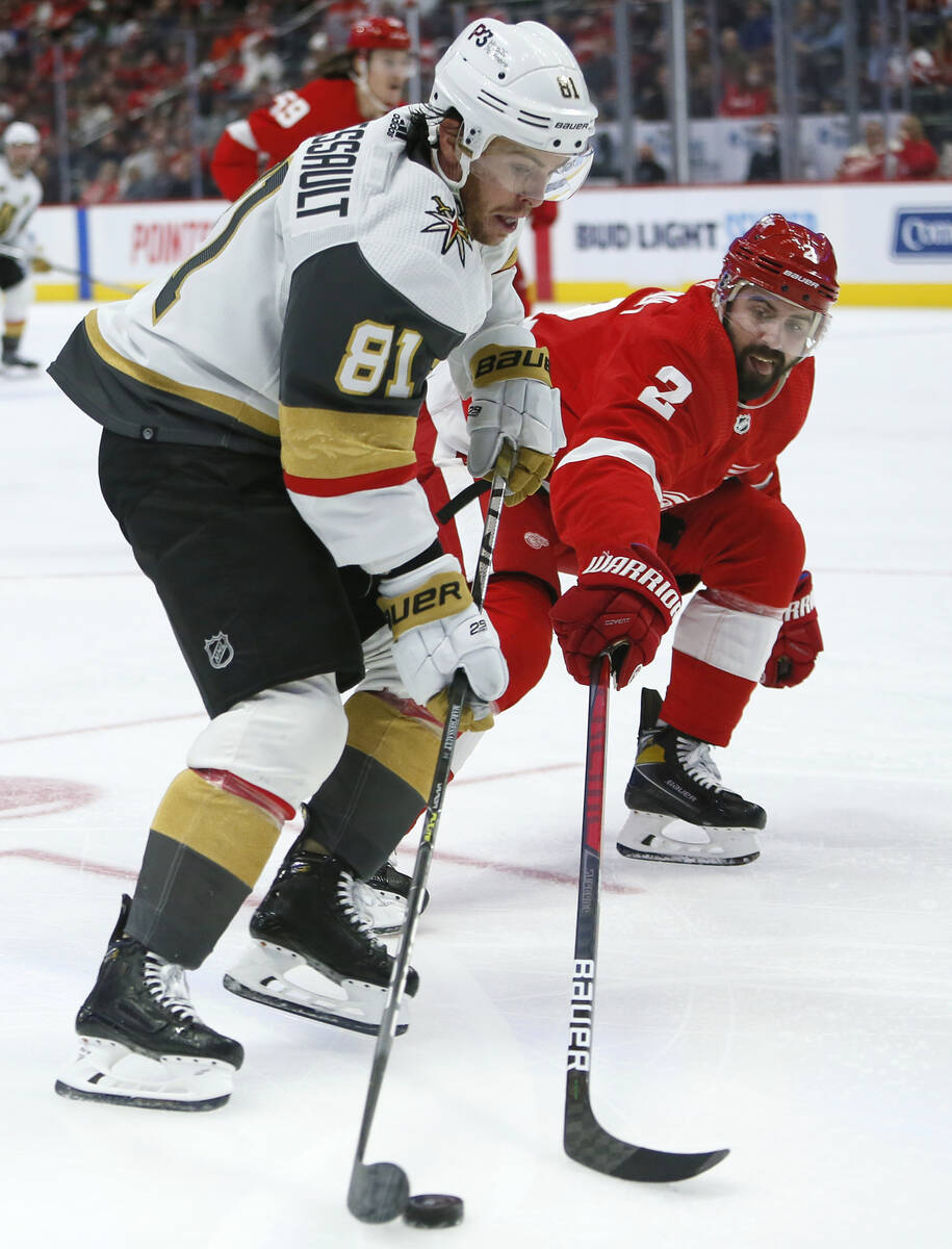 Detroit Red Wings defenseman Nick Leddy (2) tries to steal the puck from Vegas Golden Knights c ...