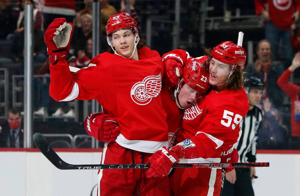 Detroit Red Wings left wing Lucas Raymond (23) celebrates with defenseman Moritz Seider (53) an ...