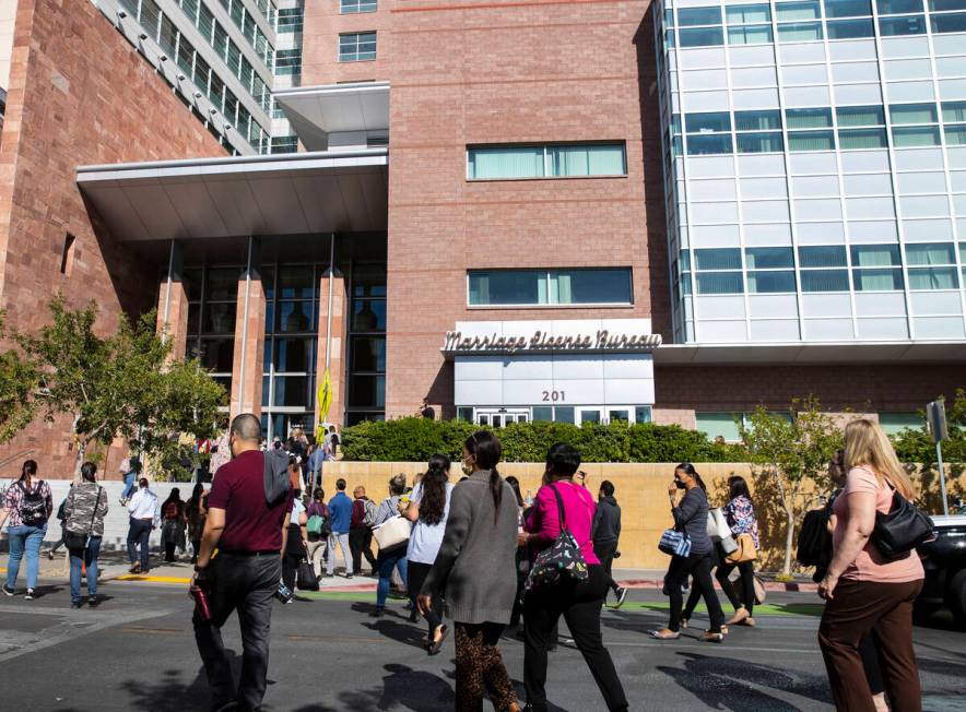 People return to the Regional Justice Center after the building was cleared because of a bomb t ...