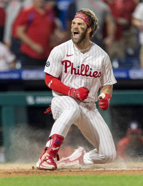 Philadelphia Phillies' Bryce Harper shouts at home plate after hitting an inside-the-park home ...