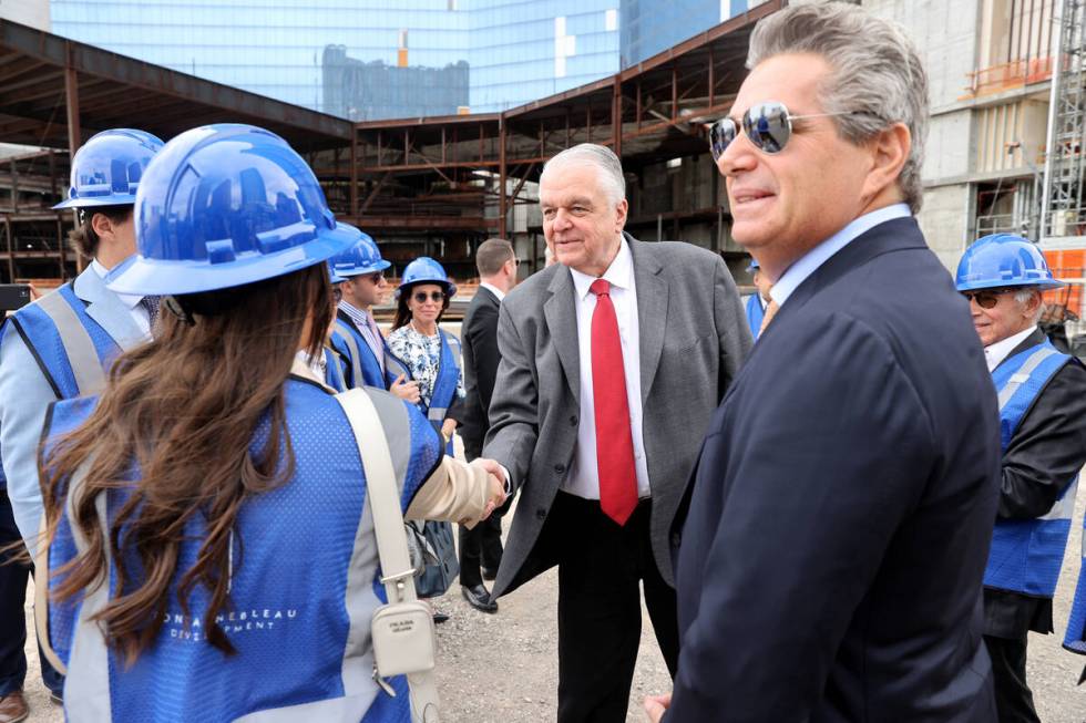 Gov. Steve Sisolak, center, mingles with Jeffrey Soffer, chairman and CEO of Fontainebleau Deve ...