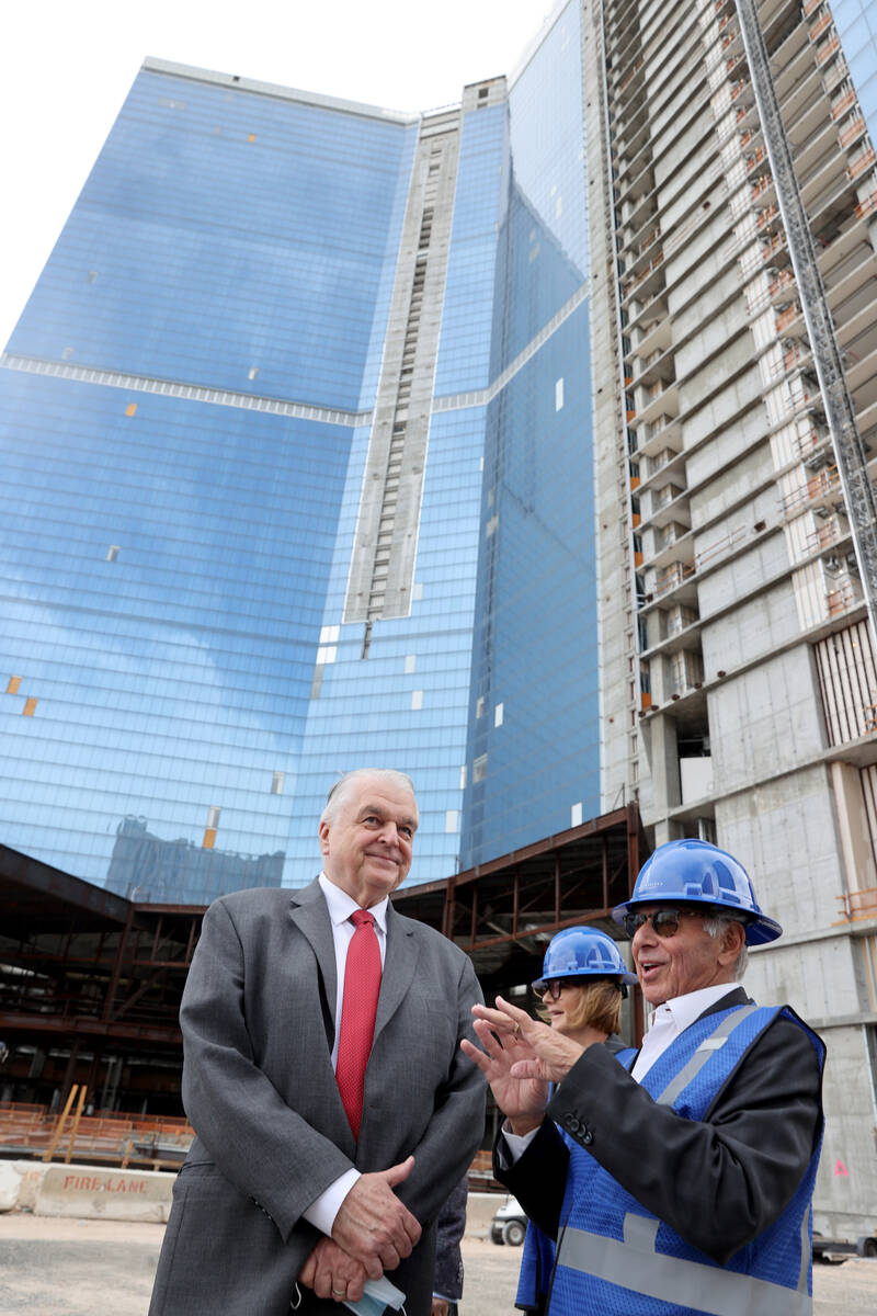 Gov. Steve Sisolak mingles with investor Joshua Saslove of Aspen, during a commencement ceremon ...