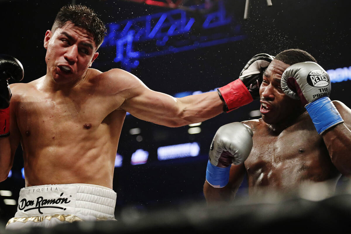 Jessie Vargas, left, hits Adrien Broner with a left during the fourth round of a welterweight b ...