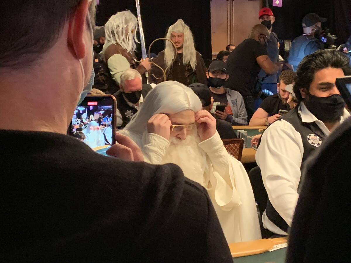 Phil Hellmuth sits down dressed as Gandalf the White from "The Lord of the Rings" on Day 1F of ...