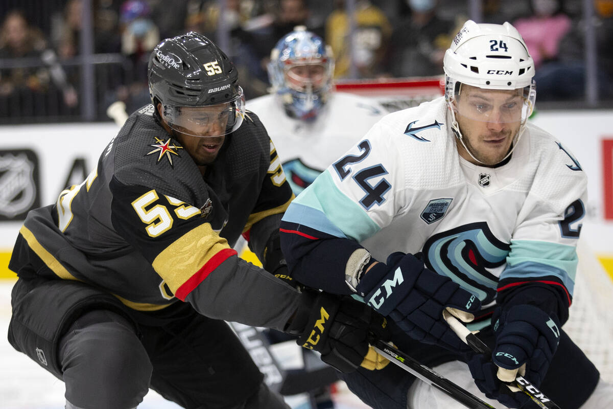 Golden Knights right wing Keegan Kolesar (55) and Kraken defenseman Jamie Oleksiak (24) compete ...