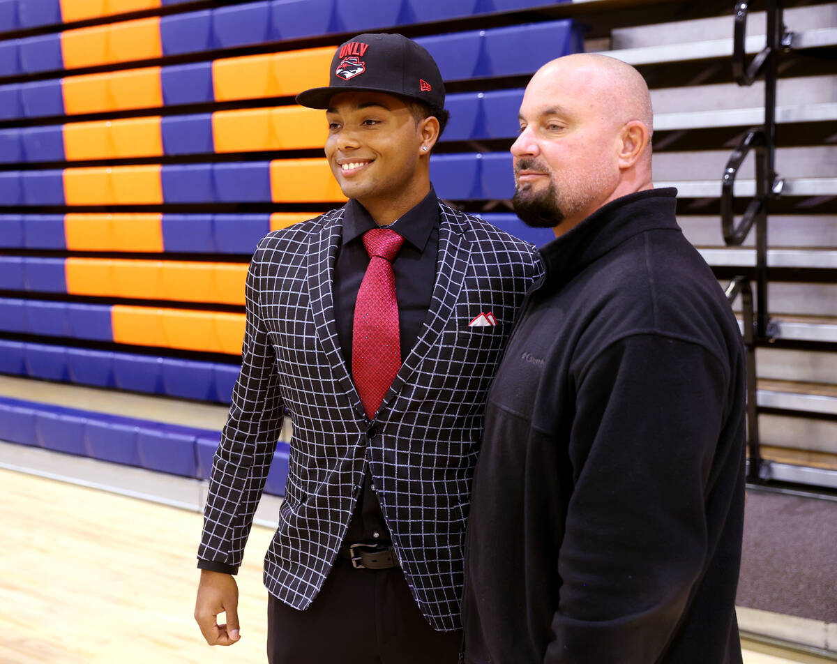 Tyler Avery poses with his coach Gino DiMaria after signing a national letter of intent to play ...