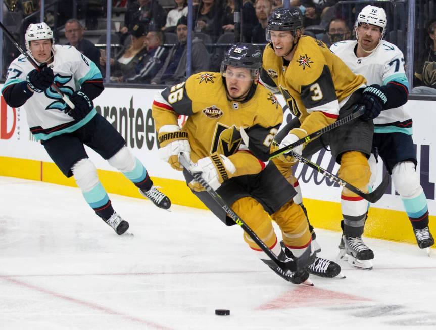 Vegas Golden Knights center Mattias Janmark (26) pushes the puck up ice past Seattle Kraken cen ...