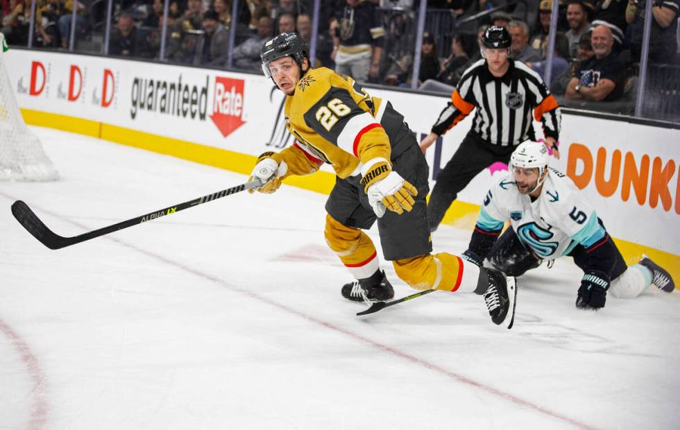 Vegas Golden Knights center Mattias Janmark (26) fights for a loose puck with Seattle Kraken de ...