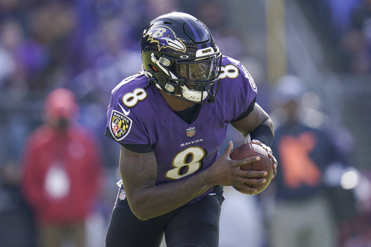 Baltimore Ravens quarterback Lamar Jackson runs with the ball against the Minnesota Vikings dur ...