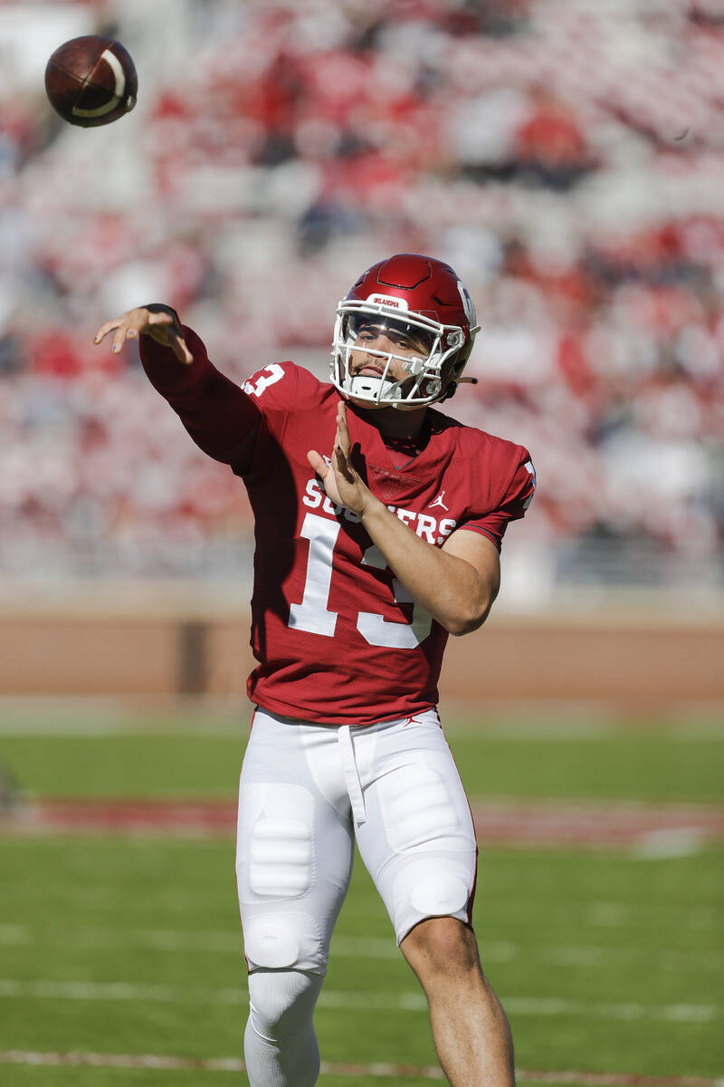 Oklahoma quarterback Caleb Williams (13) warms up before an NCAA college football game against ...