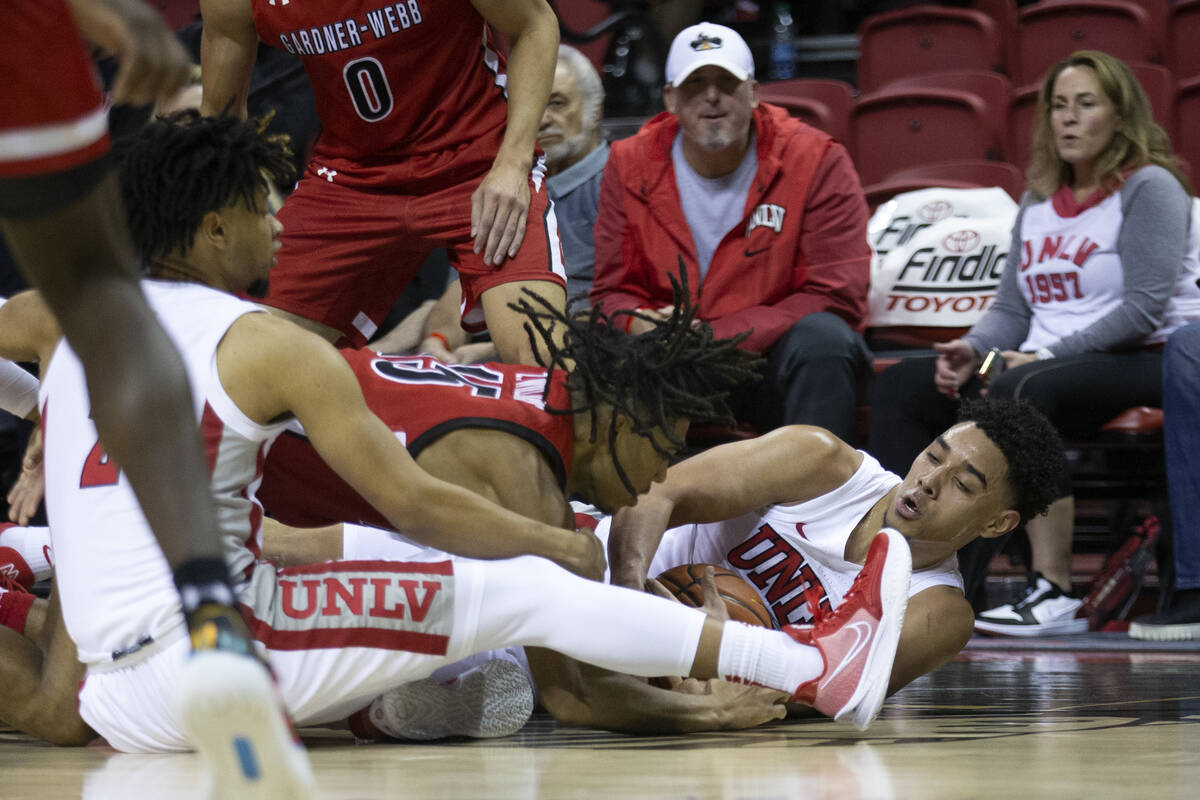 UNLV Rebels guard Marvin Coleman (31) and guard Justin Webster (2) fight for the ball with Gard ...