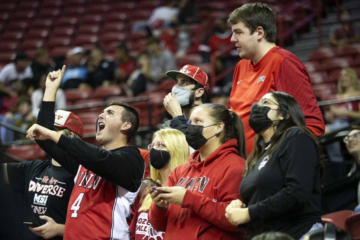 The UNLV fan section cheers for their team in the second half of a season opener NCAA men&#x573 ...