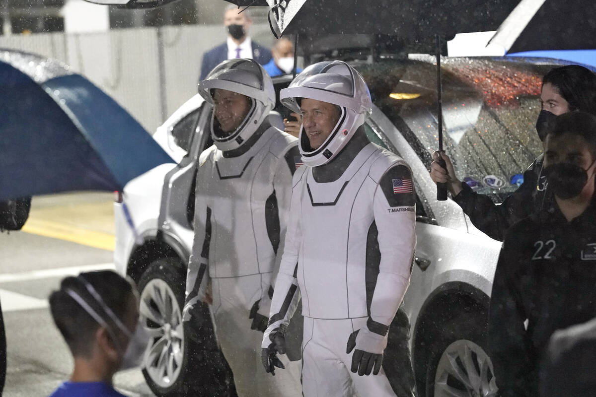 Astronauts Tom Marshburn, right, and Kayla Barron talk to family members before heading to Laun ...
