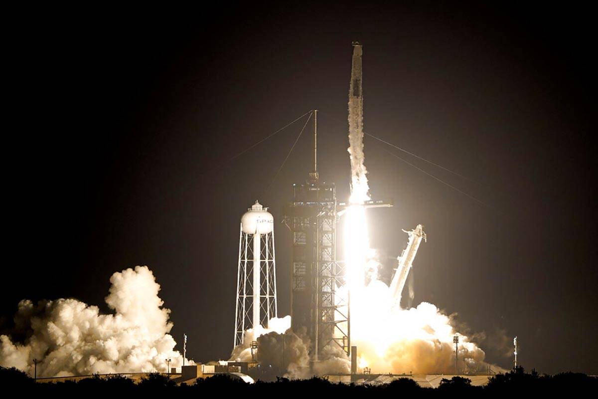 A SpaceX Falcon 9 rocket with the Crew Dragon capsule lifts off from Launch Pad 39A at the Kenn ...