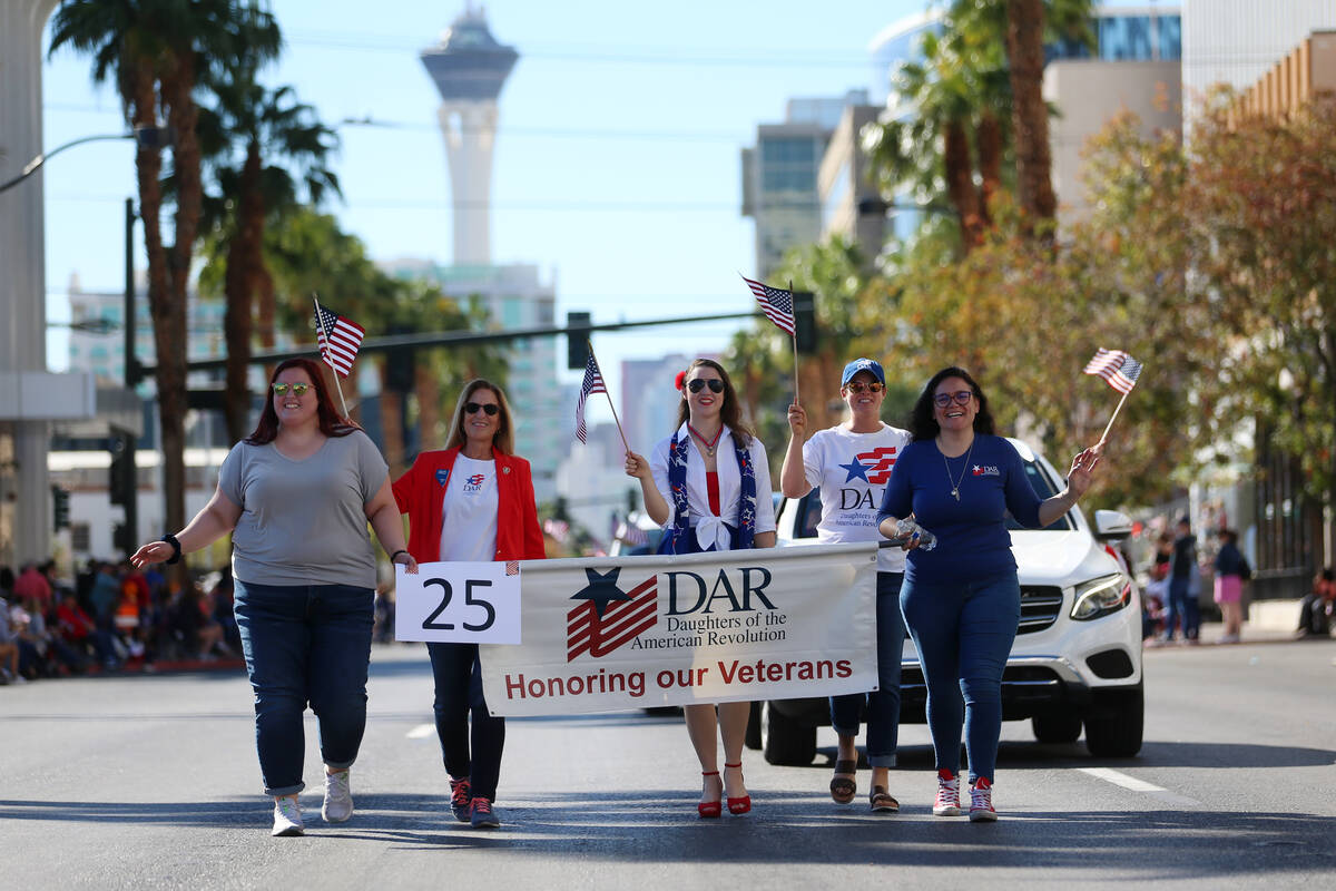 Participants make their way down the Veterans Day parade route on 4th Street in downtown Las Ve ...