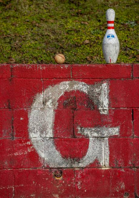 A baseball and bowling pin left on top of a wall near the football field at Robert E. Lee High ...