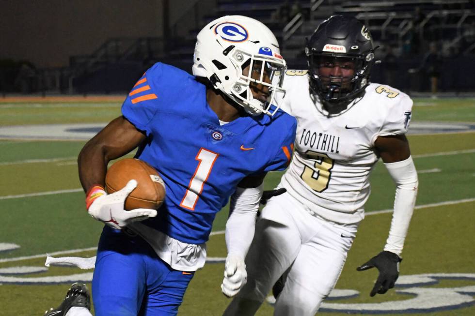 Bishop Gorman wide reciever Zachariah Branch runs from Foothill defender Kendric Thomas during ...