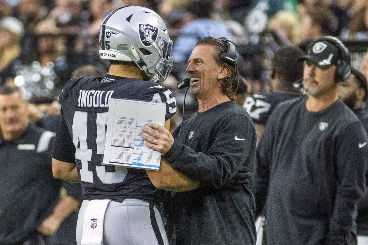 Raiders fullback Alec Ingold (45) celebrates a great play with offensive coordinator Greg Olson ...