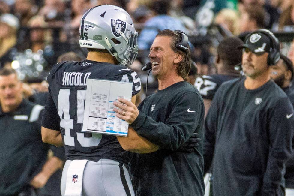 Raiders fullback Alec Ingold (45) celebrates a great play with offensive coordinator Greg Olson ...