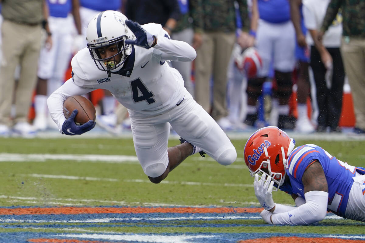Samford wide receiver Montrell Washington (4) is tripped up by Florida safety Rashad Torrence I ...