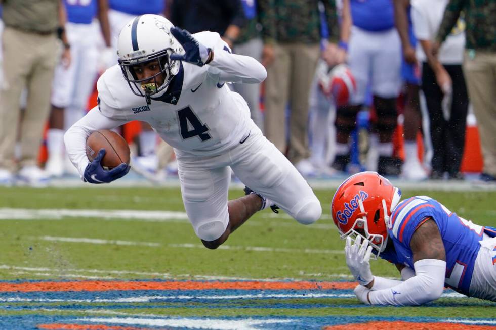 Samford wide receiver Montrell Washington (4) is tripped up by Florida safety Rashad Torrence I ...