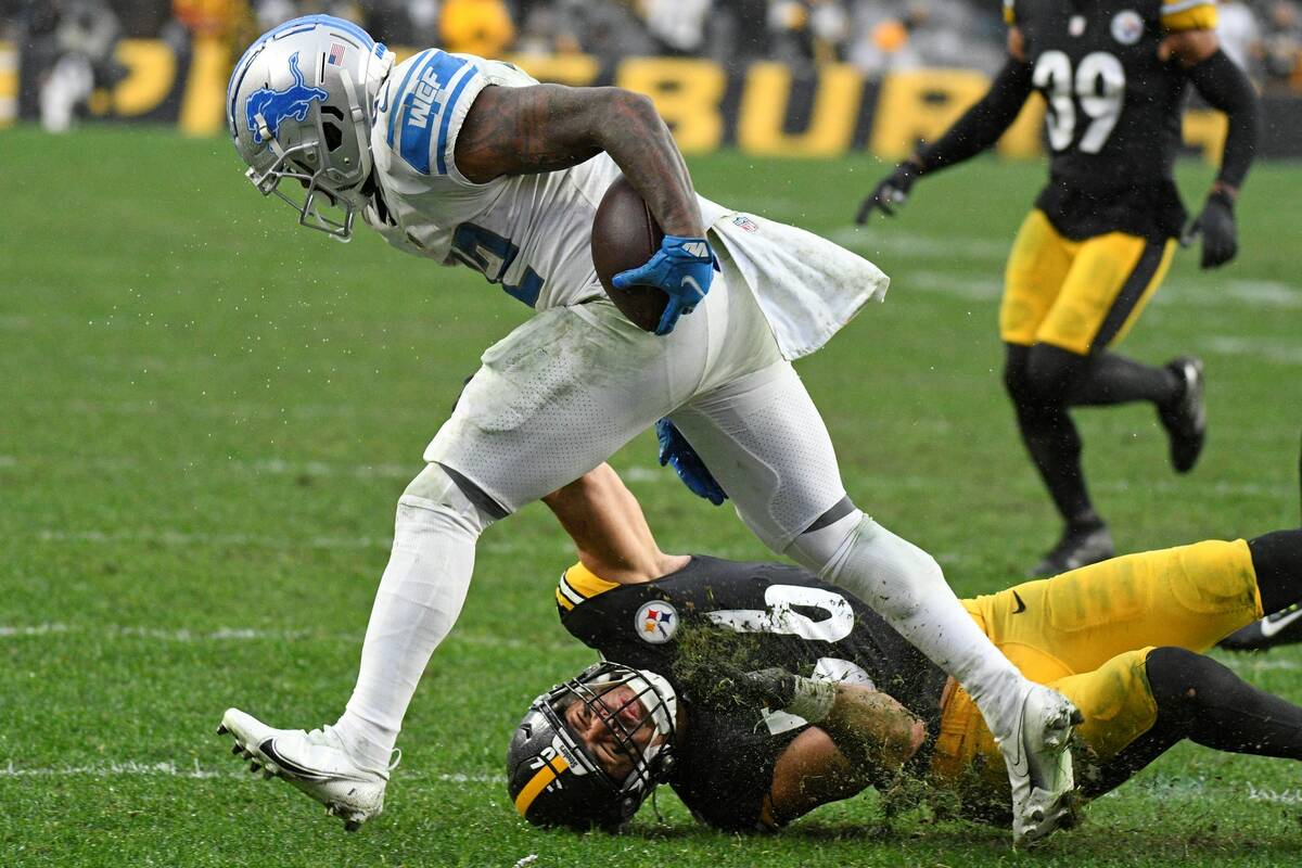 Detroit Lions running back D'Andre Swift, top, gets past Pittsburgh Steelers outside linebacker ...