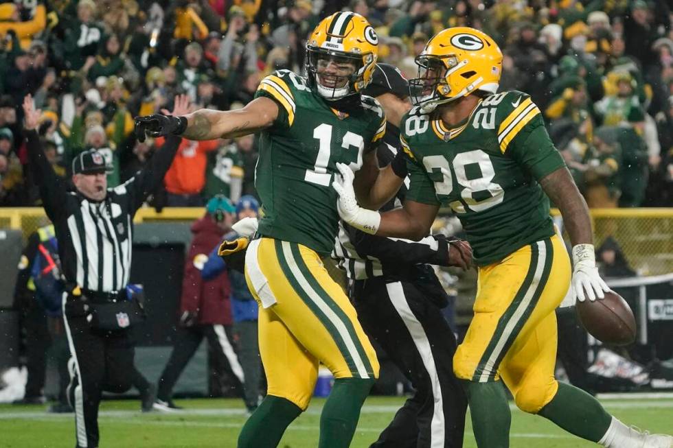 Green Bay Packers' AJ Dillon celebrates his touchdown run with Allen Lazard during the second h ...