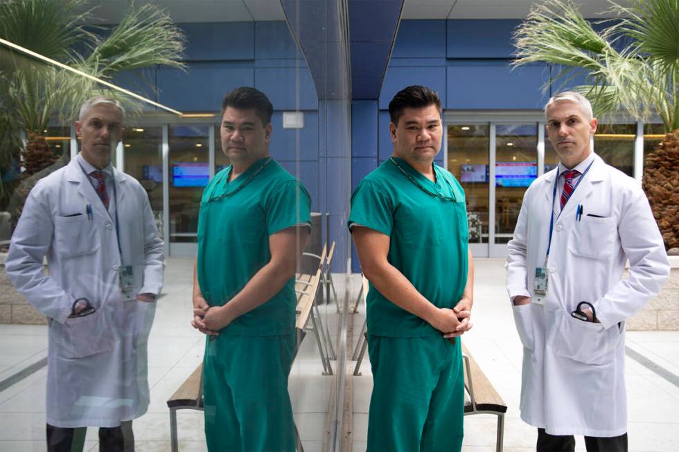 Dr. Myron Kung, a pulmonary critical care physician, left, and Dr. Jason Dazley, an infectious ...