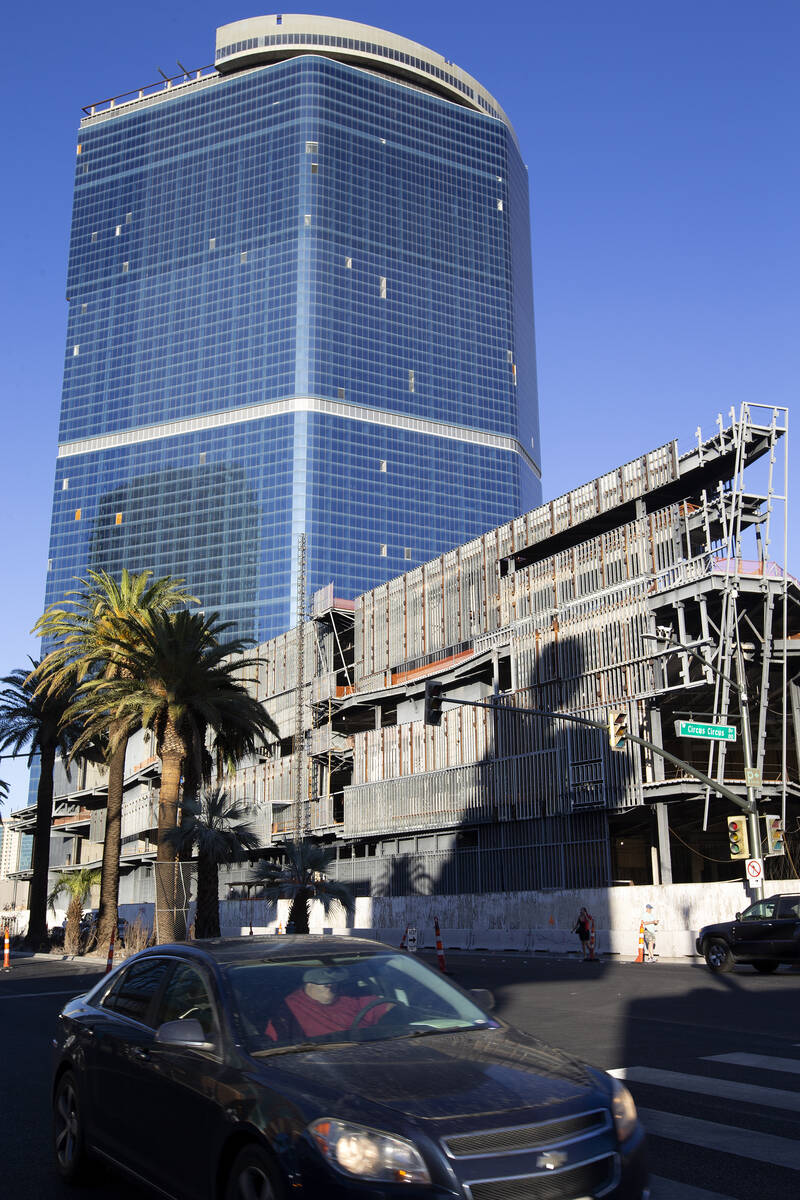 Pedestrians and traffic pass the unfinished Fontainebleau building on Thursday, Oct. 14, 2021, ...