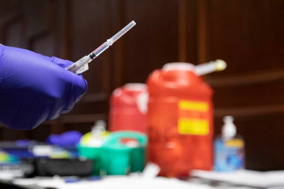 Chika McTier, a registered nurse, prepares a shot during a pop-up COVID-19 vaccine clinic at La ...