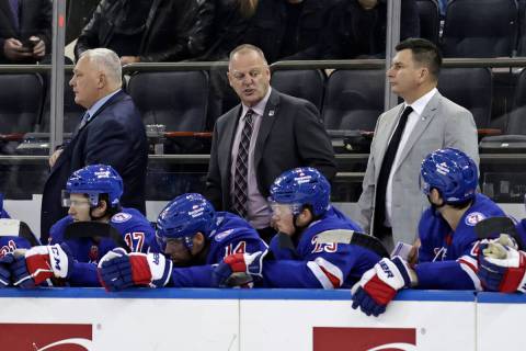 New York Rangers coach Gerard Gallant, center, talks to players during the third period of the ...