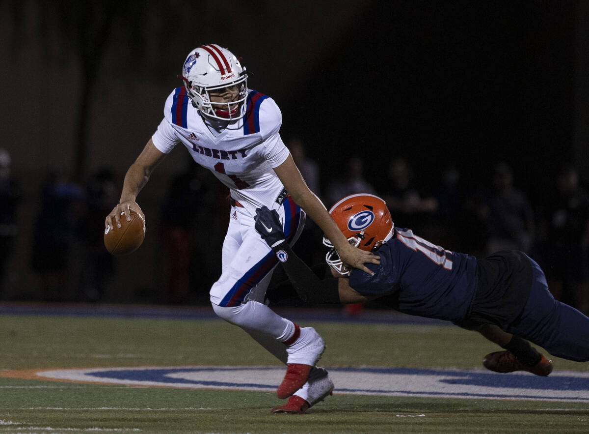 Liberty HighÕs quarterback Jayden Maiava (1) tackled by Bishop GormanÕs Cyrus Moss (1 ...