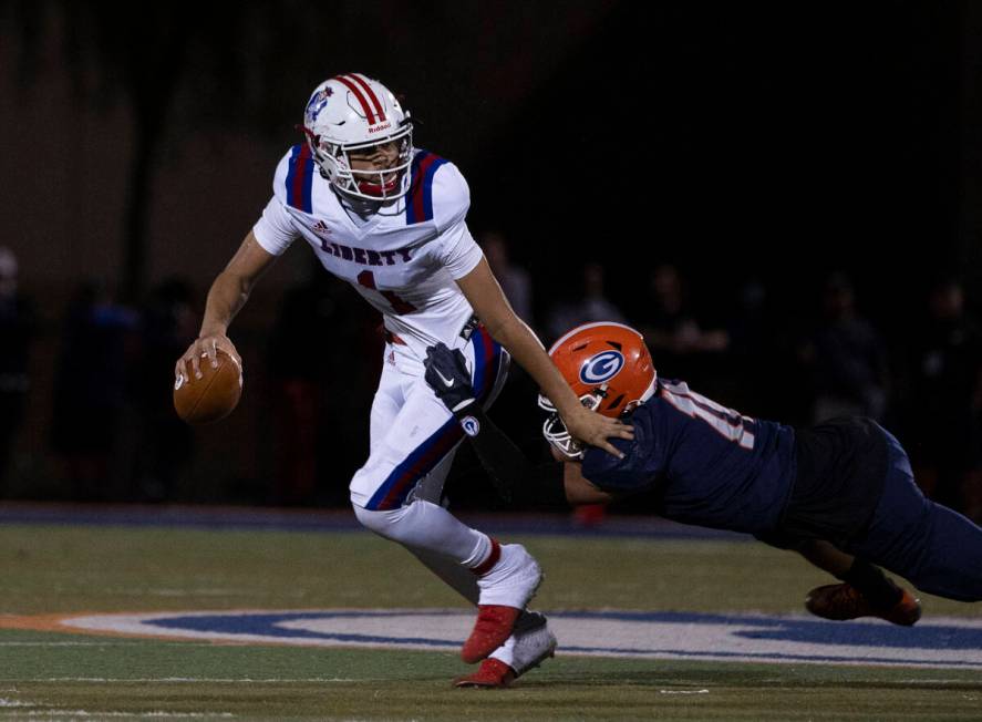 Liberty HighÕs quarterback Jayden Maiava (1) tackled by Bishop GormanÕs Cyrus Moss (1 ...