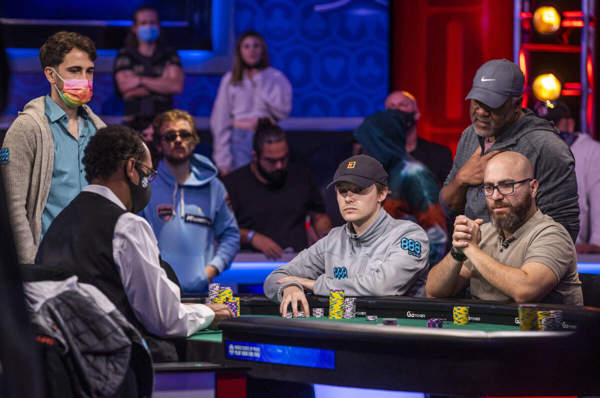Players watch a hand play out during the final table for the $10,000 buy-in Main Event at the W ...