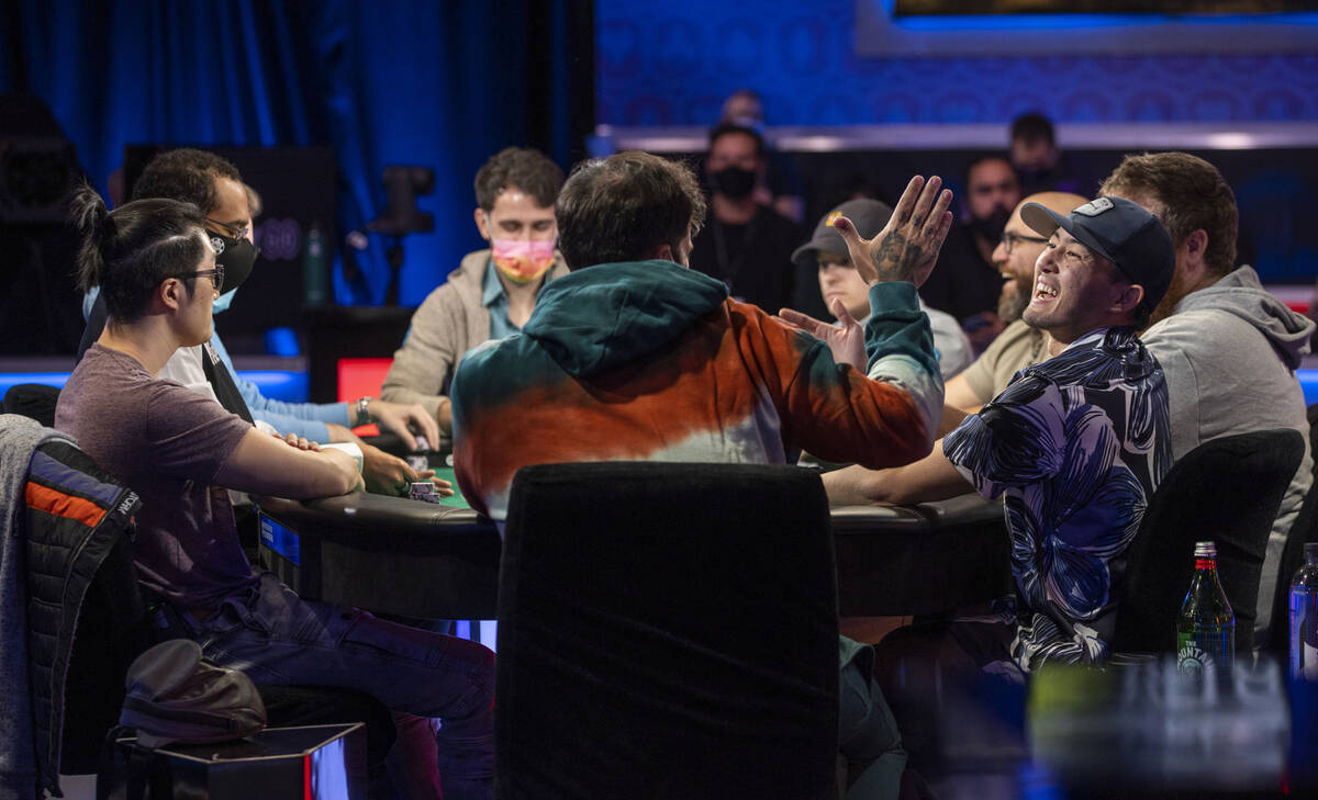 Players chat during the final table for the $10,000 buy-in Main Event at the World Series of Po ...
