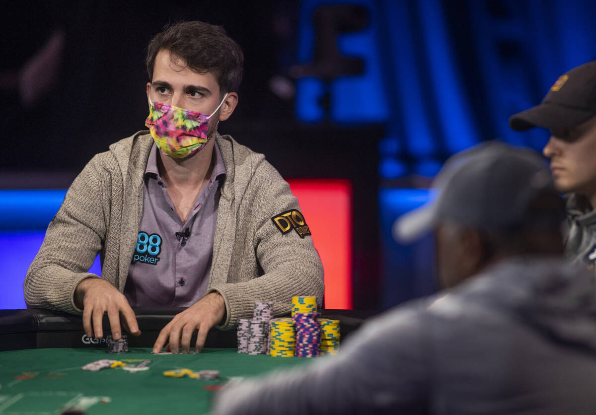 Koray Aldemir looks to the dealer with three players remaining at the final table for the $10,0 ...